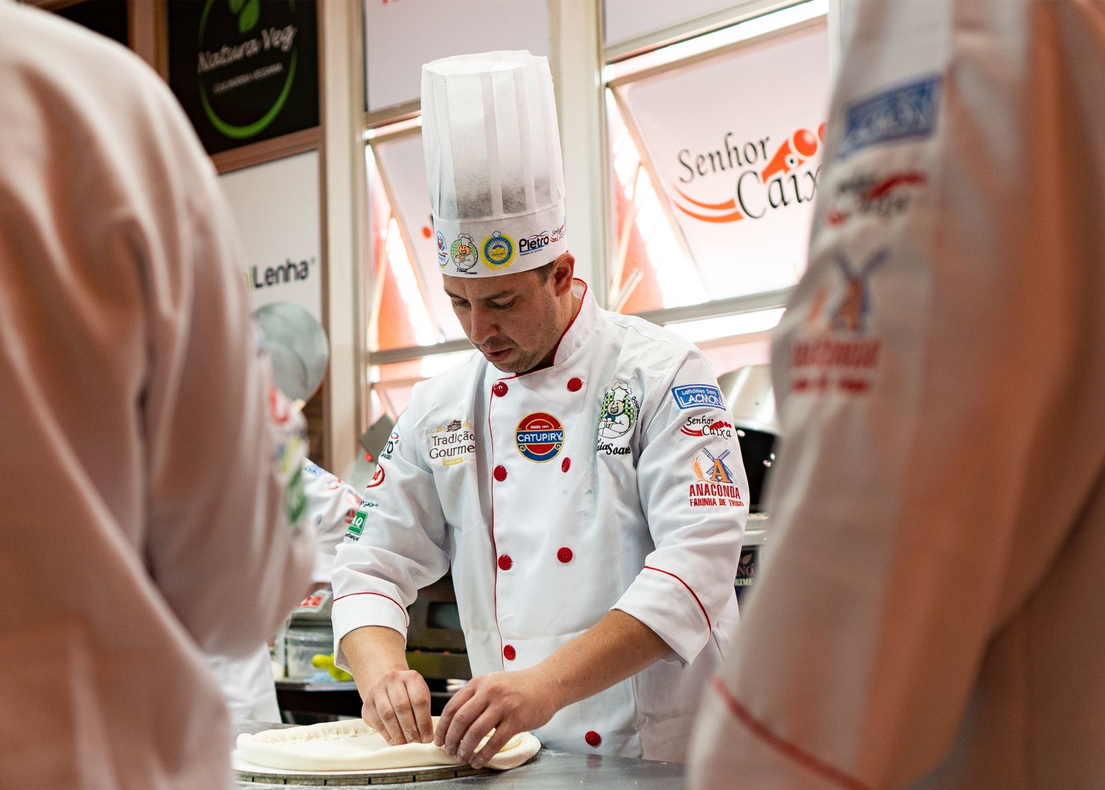 Professional pizza preparation demonstrating expert technique and quality food handling